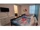 Bedroom featuring twin beds, dresser, TV, and Disney themed decor at 1544 Nassau Point Trl, Kissimmee, FL 34747
