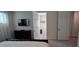 Bedroom with a TV, closet, carpet, and door leading to a walk-in closet at 1544 Nassau Point Trl, Kissimmee, FL 34747