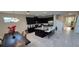 Modern kitchen with dark cabinets, granite countertops, and an island with bar seating at 1544 Nassau Point Trl, Kissimmee, FL 34747