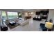 Spacious living room with a view of the pool, tile floors, and modern furniture at 1544 Nassau Point Trl, Kissimmee, FL 34747