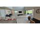 Bright, open living space with a view to the outdoors and a modern kitchen nearby at 1544 Nassau Point Trl, Kissimmee, FL 34747