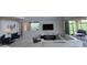 Open-concept living room with high ceilings, modern decor, and sliding doors to the outdoors at 1544 Nassau Point Trl, Kissimmee, FL 34747