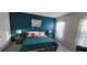 Nicely decorated bedroom featuring a teal accent wall, ceiling fan, carpet and curtains at 1544 Nassau Point Trl, Kissimmee, FL 34747