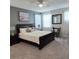 Bedroom with plush carpet, a large black bed frame, and multiple windows at 1544 Nassau Point Trl, Kissimmee, FL 34747