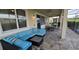 Outdoor patio with comfortable seating and a view of the pool, surrounded by lush landscaping at 1544 Nassau Point Trl, Kissimmee, FL 34747