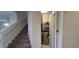 Carpeted staircase leading to the upper level with a storage closet underneath at 1544 Nassau Point Trl, Kissimmee, FL 34747