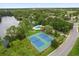 The aerial shot shows the pool and tennis court with a lake, along with the surrounding neighborhood at 189 Lakeside Cir, Sanford, FL 32773