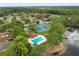 Aerial view capturing the community pool, tennis courts, lake, and neighborhood at 189 Lakeside Cir, Sanford, FL 32773