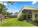 Fenced-in backyard featuring a well-maintained lawn and a screened-in porch for outdoor enjoyment at 189 Lakeside Cir, Sanford, FL 32773