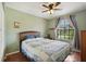 Cozy bedroom featuring a large window, a comfortable bed, and hardwood floors creating a peaceful and inviting atmosphere at 189 Lakeside Cir, Sanford, FL 32773