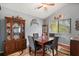 Inviting dining room with a hardwood table set, china cabinet, and modern decor, ideal for Gathering gatherings at 189 Lakeside Cir, Sanford, FL 32773