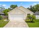 Charming single-story home with a well-maintained lawn and two-car garage, providing a welcoming curb appeal at 189 Lakeside Cir, Sanford, FL 32773