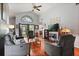 Bright living room features vaulted ceiling, rich wood flooring, large windows, and neutral decor for comfortable living at 189 Lakeside Cir, Sanford, FL 32773