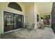 Inviting screened patio with outdoor seating and serene views of the backyard, perfect for relaxing or entertaining at 189 Lakeside Cir, Sanford, FL 32773