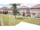 View of backyard featuring lush green grass, black metal fencing, and neighboring homes at 2002 Punch Bowl Ave, Davenport, FL 33837