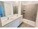 Bathroom featuring double vanity sinks, large mirror, walk in shower with tiled walls and floors at 2002 Punch Bowl Ave, Davenport, FL 33837