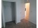 Bedroom with a walk-in closet with bi-fold doors and neutral colored carpet at 2002 Punch Bowl Ave, Davenport, FL 33837
