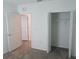 This bedroom offers ample closet space with its bright white walls, trim, and an open closet at 2002 Punch Bowl Ave, Davenport, FL 33837