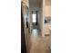 Hallway leading to rooms featuring a refrigerator on the left side at 2002 Punch Bowl Ave, Davenport, FL 33837