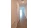 Hallway with tile flooring leading to the bright living area with natural light streaming in from the sliding glass door at 2002 Punch Bowl Ave, Davenport, FL 33837