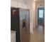 Modern kitchen features a stainless steel refrigerator and white cabinets, creating a sleek and functional space at 2002 Punch Bowl Ave, Davenport, FL 33837