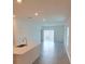 Bright, open-concept living room featuring tile floors, recessed lighting, and sliding glass doors to the backyard at 2002 Punch Bowl Ave, Davenport, FL 33837