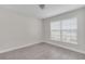 A neutral bedroom featuring tile floors, crisp white trim, and a bright window at 2044 Hillview Cir, Deltona, FL 32738
