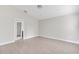 Bedroom with tile floors, neutral walls, and a view of the adjoining bathroom at 2044 Hillview Cir, Deltona, FL 32738