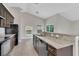 Modern kitchen featuring stainless steel appliances, granite countertops and tile flooring, offering a sleek and functional space at 2044 Hillview Cir, Deltona, FL 32738