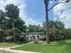 Charming single-story home with white stucco and lush landscaping at 219 Sheridan Ave, Longwood, FL 32750