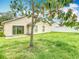 Spacious backyard with healthy green grass, sliding glass doors and partial shade at 2314 Cormorant St, Kissimmee, FL 34743