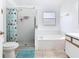 Bathroom featuring a shower, tub, toilet and window at 2314 Cormorant St, Kissimmee, FL 34743