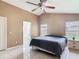 Bedroom featuring tiled floors, a high ceiling, and an ensuite bathroom at 2314 Cormorant St, Kissimmee, FL 34743