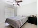 Bright bedroom featuring a ceiling fan, tiled flooring, and a large window at 2314 Cormorant St, Kissimmee, FL 34743