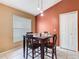 Cozy dining area featuring a dark wood table, four chairs, and modern pendant lighting at 2314 Cormorant St, Kissimmee, FL 34743