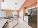 Functional kitchen layout with white cabinets, tile flooring, and essential appliances, ideal for cooking at 2314 Cormorant St, Kissimmee, FL 34743