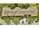 Aerial view of townhome roofs in neighborhood with mature trees and sidewalks at 2343 Caravelle Cir, Kissimmee, FL 34746