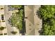Aerial view of townhome roofs in neighborhood with mature trees and sidewalks at 2343 Caravelle Cir, Kissimmee, FL 34746