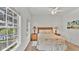 Cozy bedroom featuring bright windows and natural light with views of the lake at 2343 Caravelle Cir, Kissimmee, FL 34746