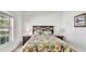 Bedroom with a large window and beautiful floral bedding for a bright and inviting space at 2343 Caravelle Cir, Kissimmee, FL 34746