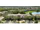 Exterior view of pink townhomes with mature landscaping and sidewalks in a lush community near a lake at 2343 Caravelle Cir, Kissimmee, FL 34746