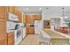 Bright eat-in kitchen with modern appliances, oak cabinets, and tile flooring at 2343 Caravelle Cir, Kissimmee, FL 34746