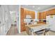 Well-lit kitchen with white appliances, light wood cabinets, and an eat-in area at 2343 Caravelle Cir, Kissimmee, FL 34746