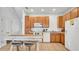 Eat-in kitchen showcasing white appliances, neutral tile flooring, and ample cabinet space at 2343 Caravelle Cir, Kissimmee, FL 34746