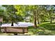 Scenic lake view with a bench, framed by lush trees, offering a peaceful spot to enjoy nature at 2343 Caravelle Cir, Kissimmee, FL 34746