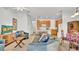 Cozy living room featuring comfortable seating, a TV, and access to the kitchen area at 2343 Caravelle Cir, Kissimmee, FL 34746