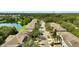 A street view of multi-Gathering homes near a pond in a neighborhood with mature trees and well maintained landscaping at 2343 Caravelle Cir, Kissimmee, FL 34746