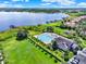 An aerial view showcases the community pool with a playground and walking path with access to a lake at 2359 Baronsmede Ct, Winter Garden, FL 34787