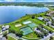An aerial view highlights the community amenities with a lake, boardwalk, and a pool with a clubhouse nearby at 2359 Baronsmede Ct, Winter Garden, FL 34787