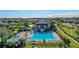 The community pool features a sundeck, lounge chairs, tables, and umbrellas, with a clubhouse nearby at 2359 Baronsmede Ct, Winter Garden, FL 34787
